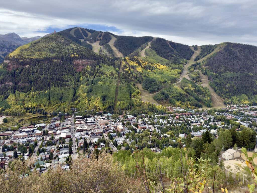View along the trail of the Telluride ski slopes, and the town below.