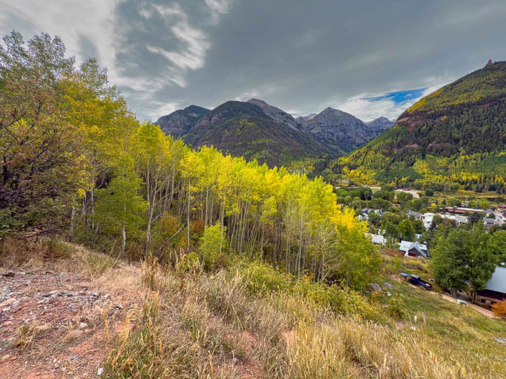 A spectacular view of the edge of Telluride, and 9+ mountain peaks in the distance.