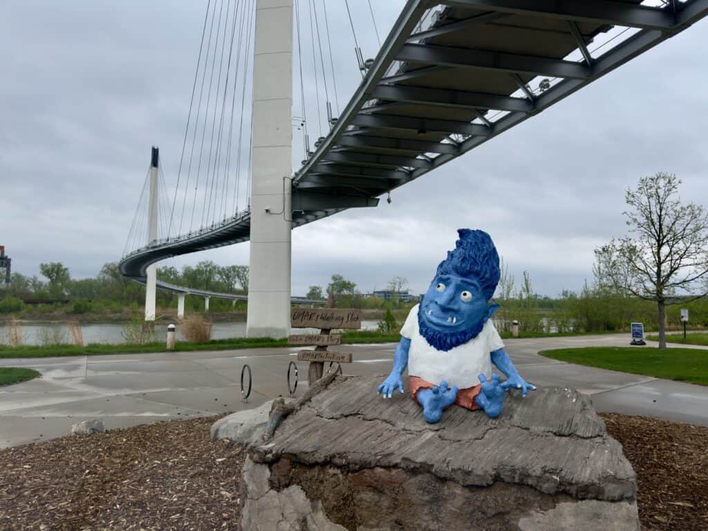 Omar the blue troll sits below the bridge.