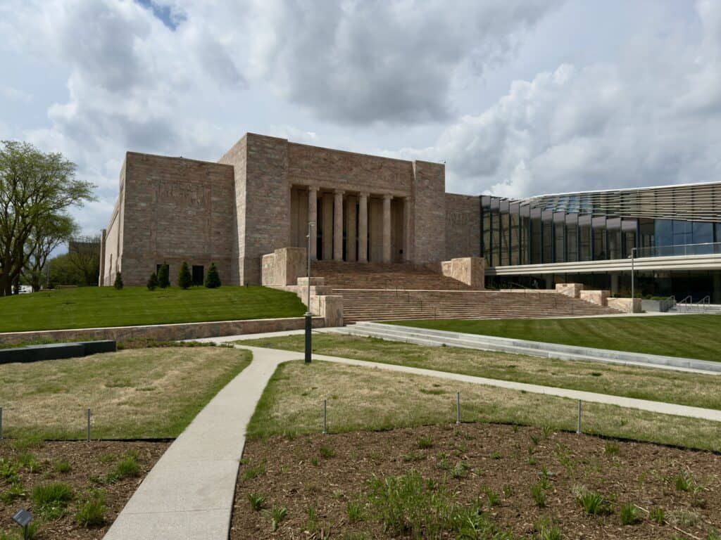 The handsome exterior of the Joslyn with the grounds stretched out in front of it.