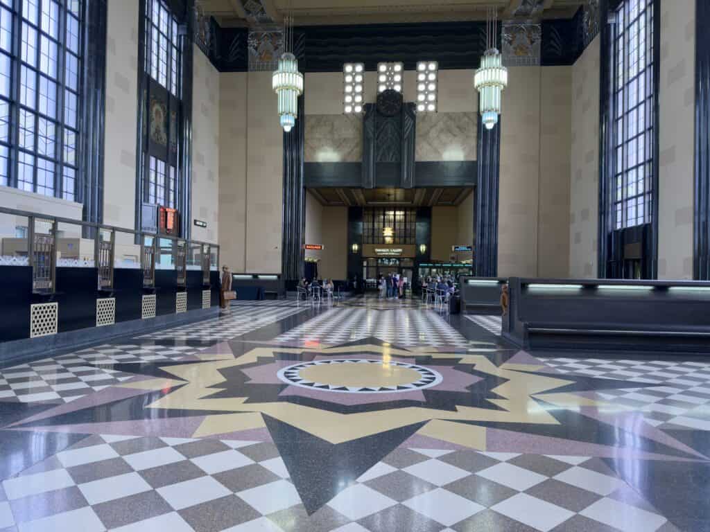 The Great Hall, with marble floors, 60' ceilings, floor-to-ceiling windows, and extravagant chandeliers.