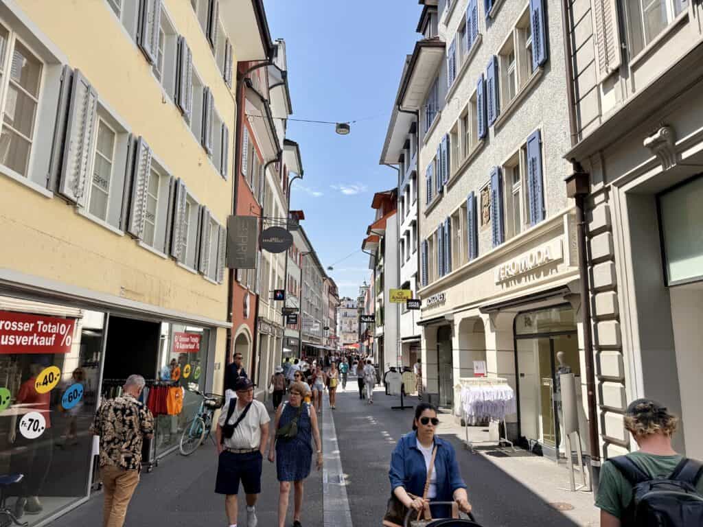 Visitors walking through another narrow Old Town street.
