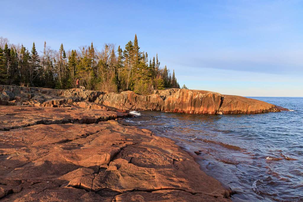 Artist's Point with a forest and ledges of uneven basalt rock.