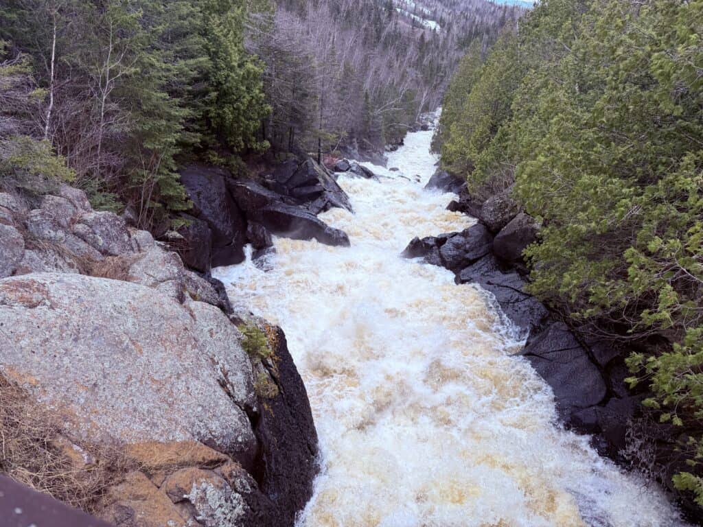 The thundering falls heading downtream as viewed from the bridge.