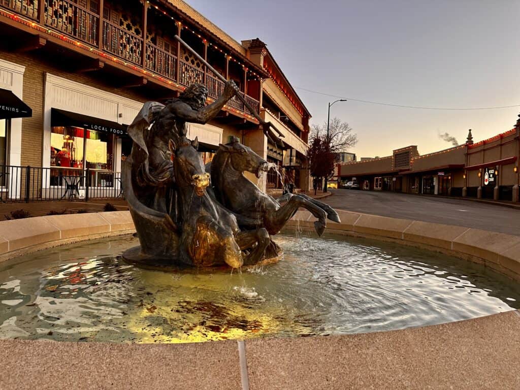 Fountain in the Country Club Plaza with a bronze statue of Poseidon in a chariot, raising his trident over the horses.