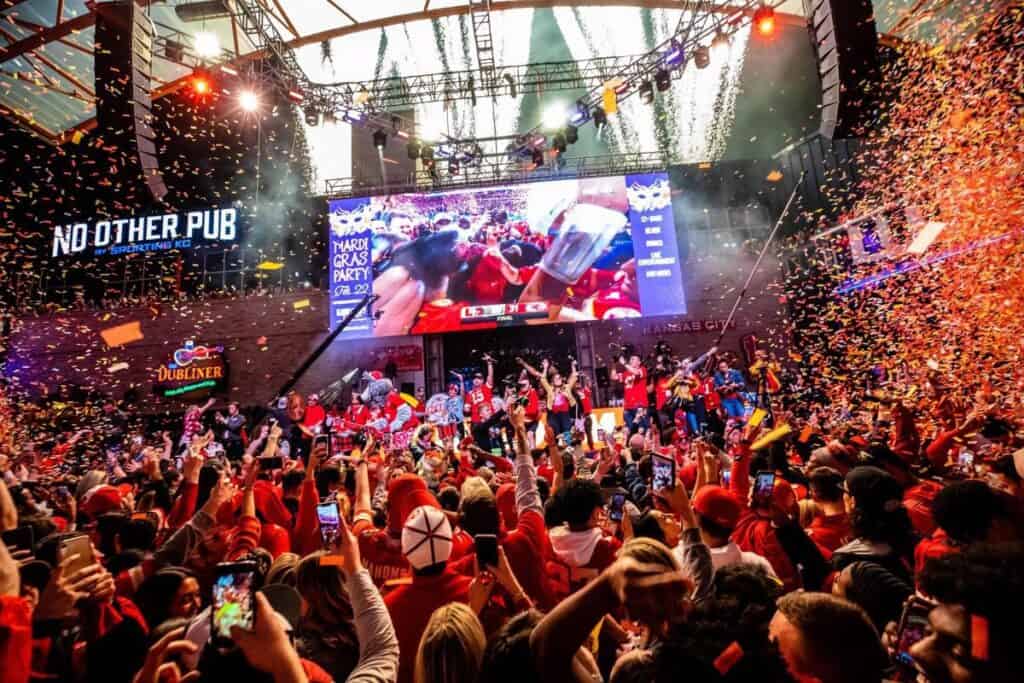 Huge crowds gather around an enormous screen in Kansas City's Power and Light District